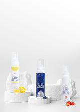 Three bottles of whipped cream with different flavors on a white background